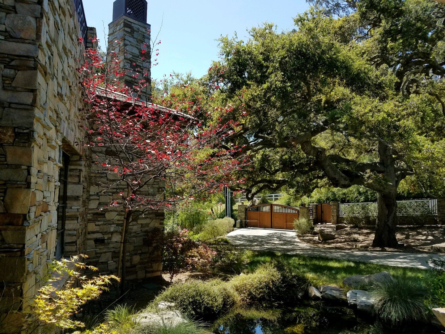 mortar and stone walls with bushes and a pond